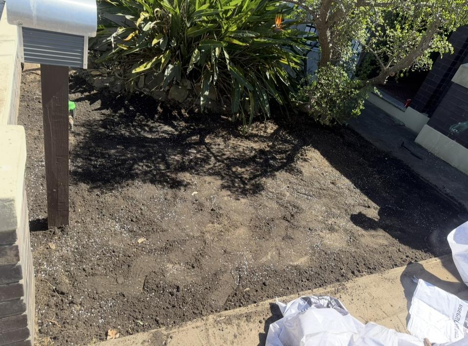 Front yard with bare, prepared soil before new turf was laid